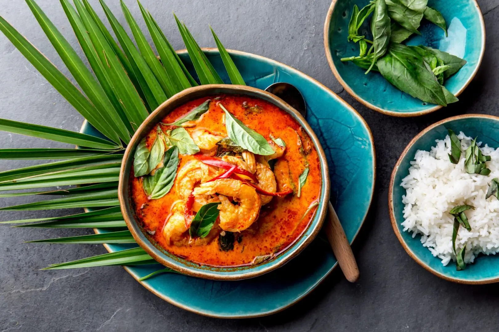 A bowl of soup with shrimp and rice.