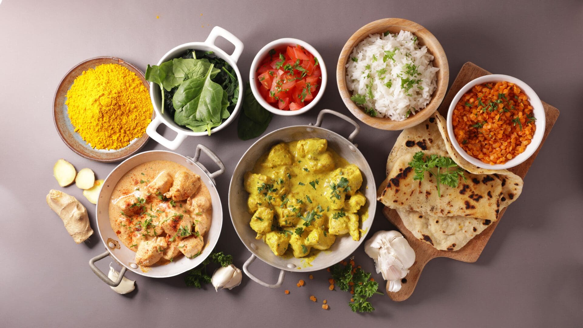 A table topped with bowls of food and rice.