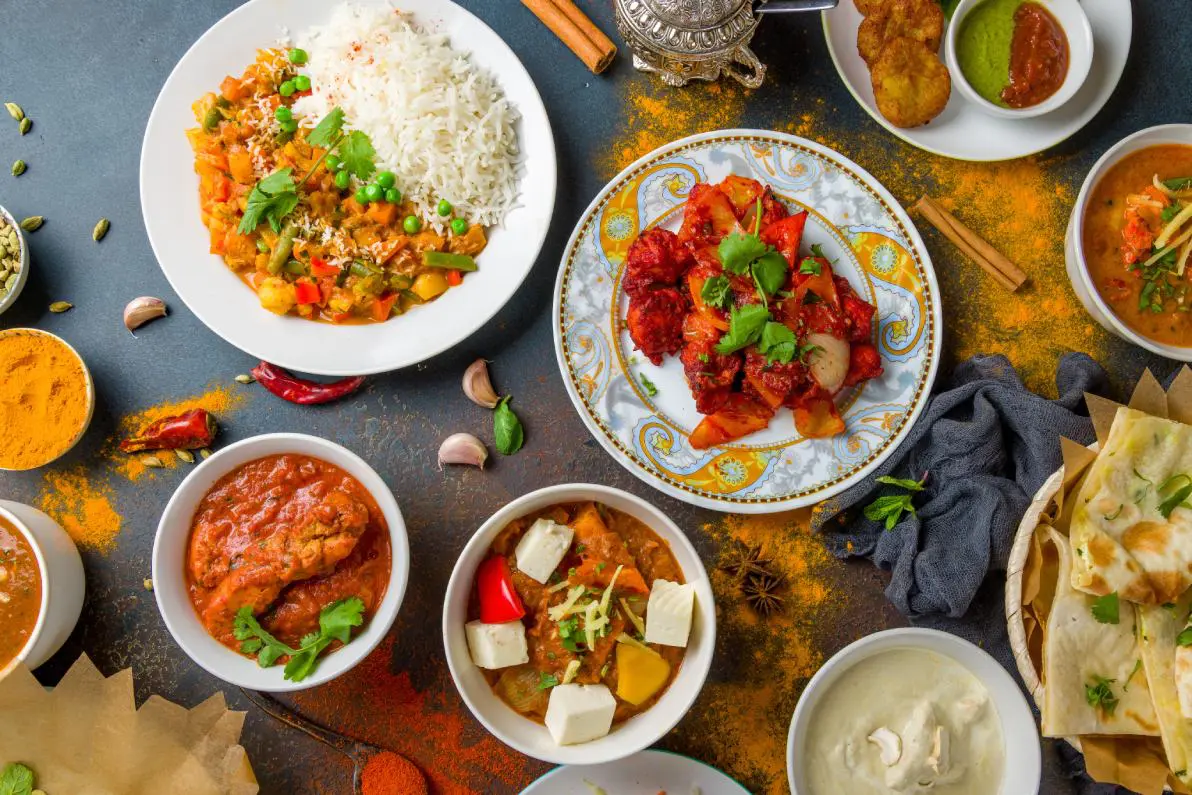 A table filled with plates of food and bowls.