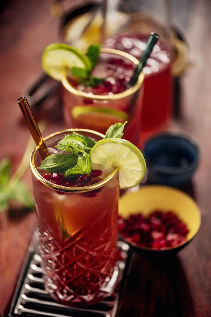 Two glasses of iced tea with a lemon and mint garnish.