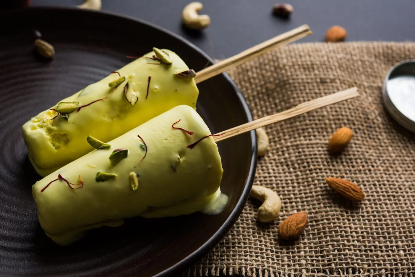 Two cones of food on a plate with nuts.