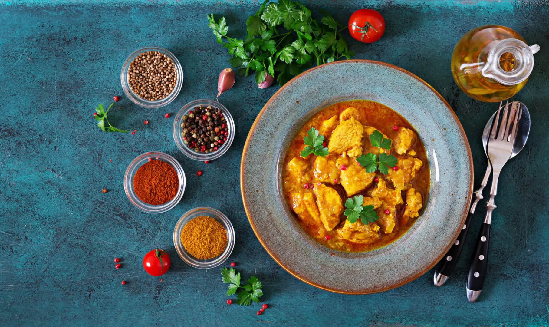 A bowl of food with some spices on the side