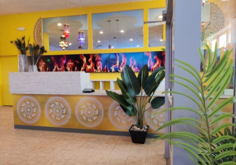 Ornate reception desk in yellow room.