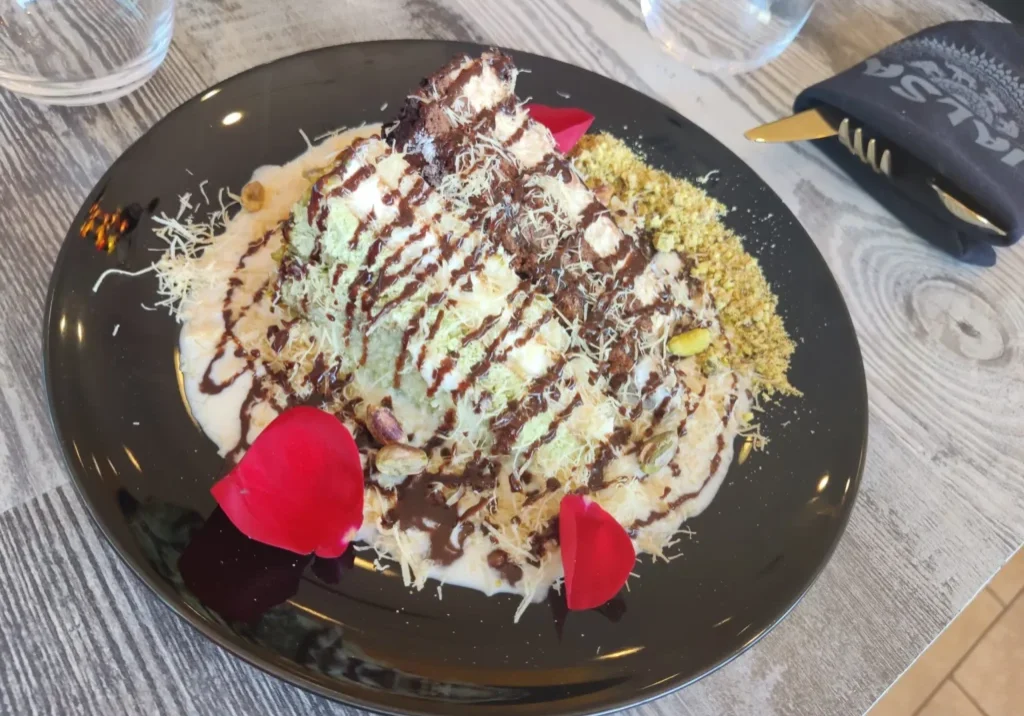 Pistachio and chocolate dessert on plate.